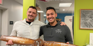 Two High Flight Academy students celebrating their Checkride by signing the commemorative propeller.